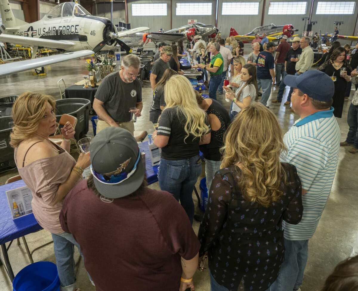 Beer lovers enjoy a night of tasting 04/06/19 at the High Sky Wing of the CAF Hops & Props fundraiser in the High Sky Wing hanger. Tim Fischer/Reporter-Telegram