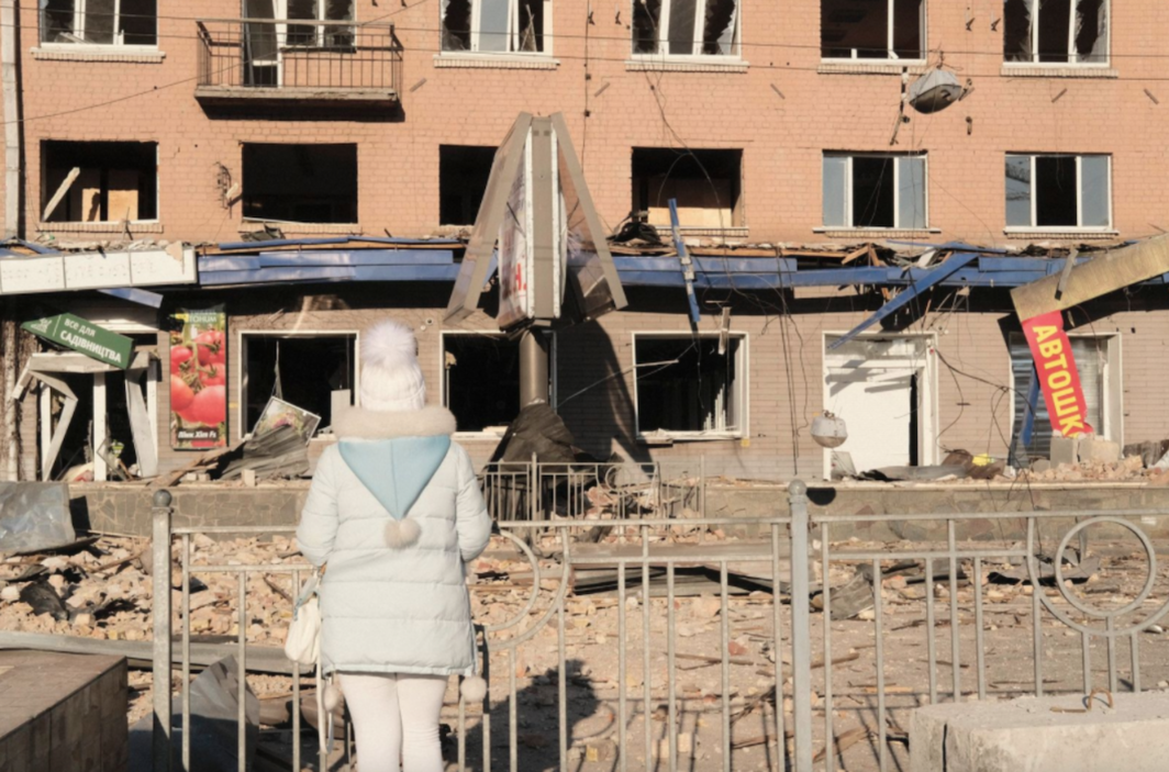 A passerby in front of one of the buildings destroyed yesterday in the city center.