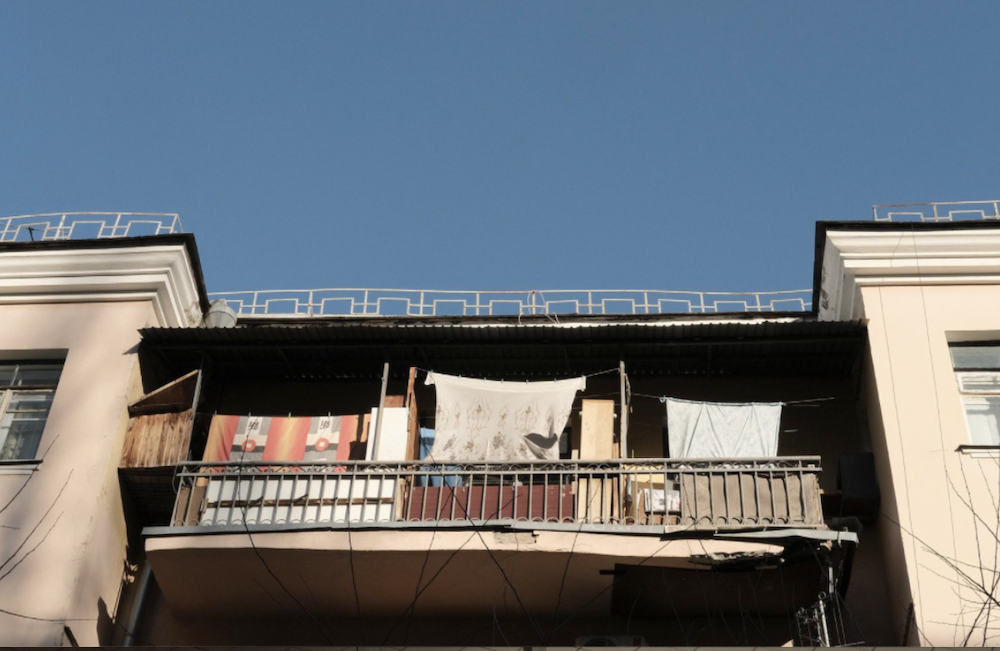 The apartments in Kyiv look peaceful, even in the midst of or some such war. Neighborhood balconies are blanketed in colorful bedsheets, which are supposed to protect and disguise residents.