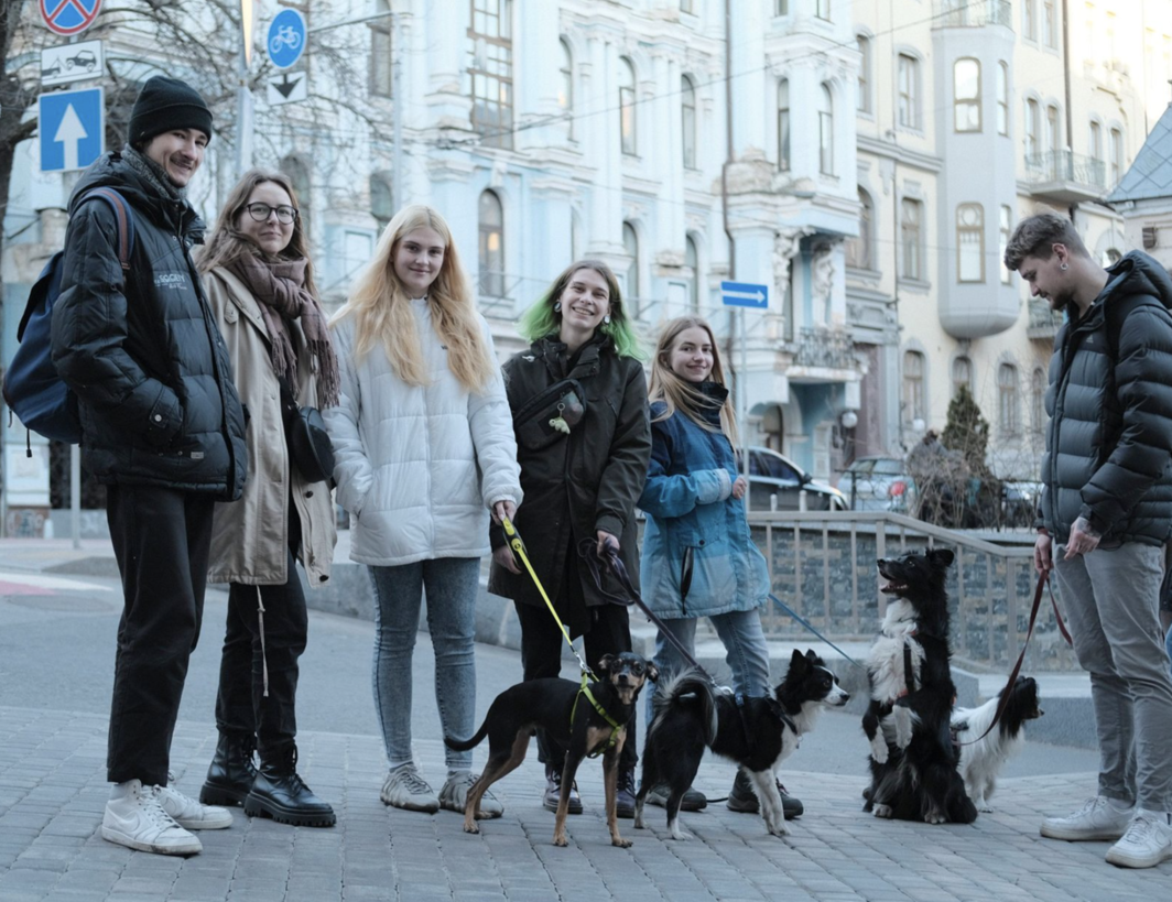 A group of friends, colleagues, and veterinarians walking their dogs before the long curfew. They are staying in Kyiv to rescue animals.