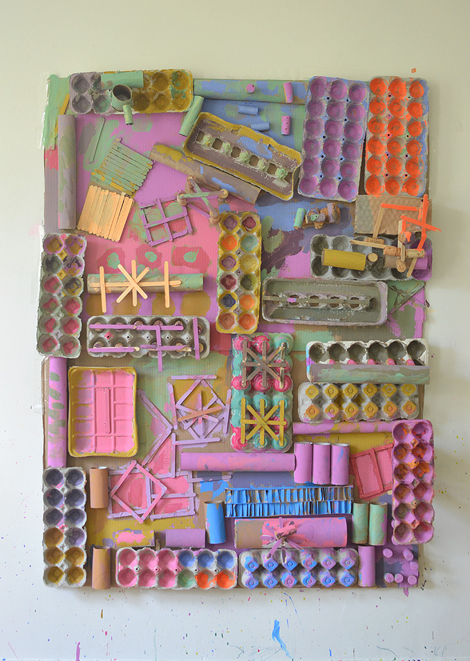 Glue a whole bunch of recyclables onto a big piece of cardboard, then let the kids paint!